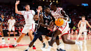 Nov 13, 2024; Lincoln, Nebraska, USA; Nebraska Cornhuskers forward Juwan Gary (4) drives against Fairleigh Dickinson Knights guard Ahmed Barba-Bey (8) during the first half at Pinnacle Bank Arena.