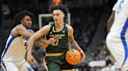 Mar 21, 2025; Seattle, WA, USA; Colorado State Rams guard Kyan Evans (0) drives the ball past Memphis Tigers guard PJ Haggerty (4) during the second half at Climate Pledge Arena.