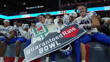 Dec 26, 2023; Phoenix, AZ, USA; Kansas Jayhawks players celebrate after defeating the UNLV Rebels at the Guaranteed Rate Bowl