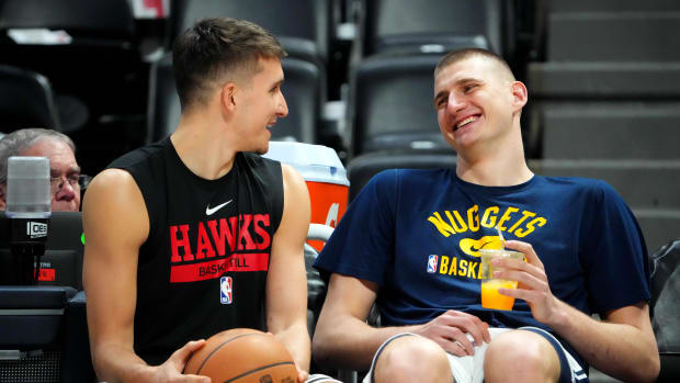 Bogdan Bogdanovic speaks to Denver Nuggets center Nikola Jokic