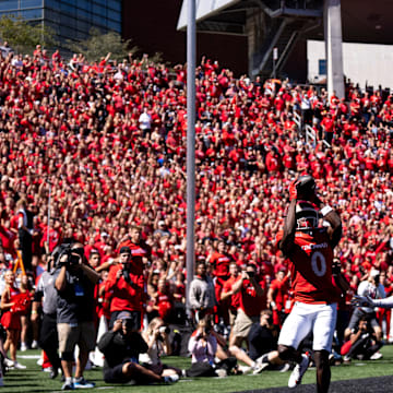 Cincinnati Bearcats wide receiver Tony Johnson (0) scores a touchdown as Pittsburgh Panthers defensive back Rashad Battle (15) in the first quarter of the College Football game at Nippert Stadium in Cincinnati on Saturday, Sept. 7, 2024.