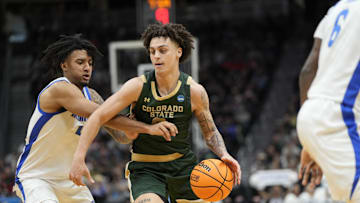 Mar 21, 2025; Seattle, WA, USA; Colorado State Rams guard Kyan Evans (0) drives the ball past Memphis Tigers guard PJ Haggerty (4) during the second half at Climate Pledge Arena. Mandatory Credit: Stephen Brashear-Imagn Images
