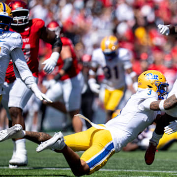 Cincinnati Bearcats running back Corey Kiner (21) breaks a tackle attempt by Pittsburgh Panthers defensive back Donovan McMillon (3) in the third quarter of the College Football game at Nippert Stadium in Cincinnati on Saturday, Sept. 7, 2024.