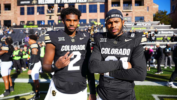 Nov 29, 2024; Boulder, Colorado, USA; Colorado Buffaloes quarterback Shedeur Sanders (2) and safety Shilo Sanders (21) pose 