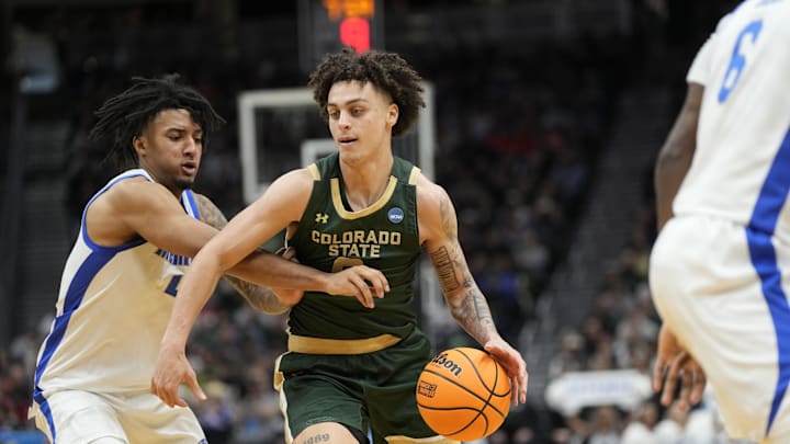 Mar 21, 2025; Seattle, WA, USA; Colorado State Rams guard Kyan Evans (0) drives the ball past Memphis Tigers guard PJ Haggerty (4) during the second half at Climate Pledge Arena. Mandatory Credit: Stephen Brashear-Imagn Images