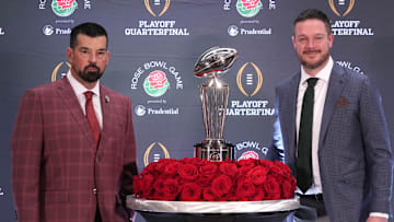 Dec 31, 2024; Los Angeles, California, USA; Ohio State Buckeyes head coach Ryan Day (left) and Oregon Ducks head coach Dan Lanning pose with the Leishman Trophy during the Rose Bowl head coaches press conference at Sheraton Grand LA. Mandatory Credit: Kirby Lee-Imagn Images