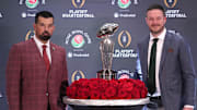 Dec 31, 2024; Los Angeles, California, USA; Ohio State Buckeyes head coach Ryan Day (left) and Oregon Ducks head coach Dan Lanning pose with the Leishman Trophy during the Rose Bowl head coaches press conference at Sheraton Grand LA. Mandatory Credit: Kirby Lee-Imagn Images