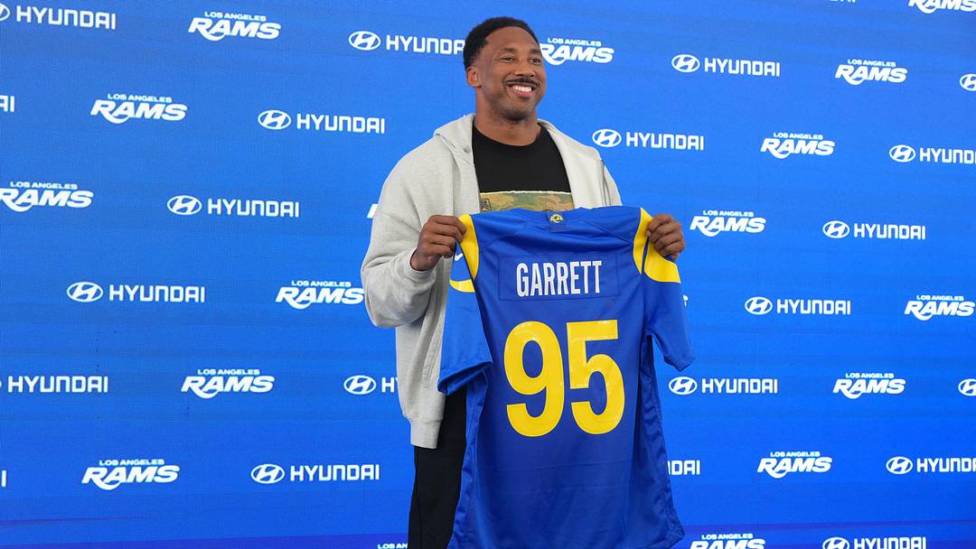 Jun 2, 2026; Woodland Hills, CA, USA; Los Angeles Rams defensive end Myles Garrett (95) poses with jersey at press conference at Rams Practice Facility. Mandatory Credit: Kirby Lee-Imagn Images