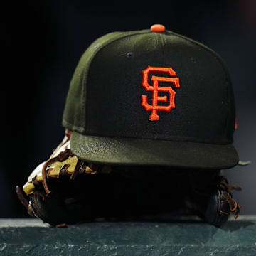 General view of a San Francisco Giants cap and glove during the ninth inning against the Colorado Rockies at Coors Field. 