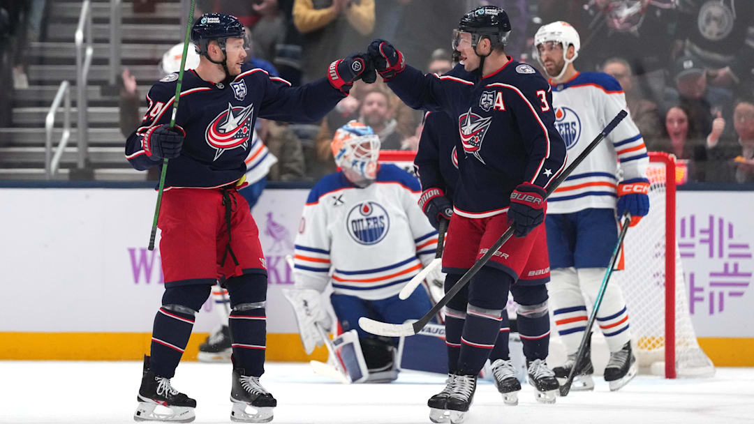 Blue Jackets forwards Mathieu Olivier and Charlie Coyle celebrate a goal against the Edmonton Oilers.