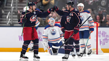 Blue Jackets forwards Mathieu Olivier and Charlie Coyle celebrate a goal against the Edmonton Oilers.
