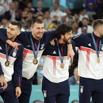 Serbia center Nikola Jokic (15) celebrates on the podium with teammates after winning the bronze medal in men's basketball during the Paris 2024 Olympic Summer Games at Accor Arena. 