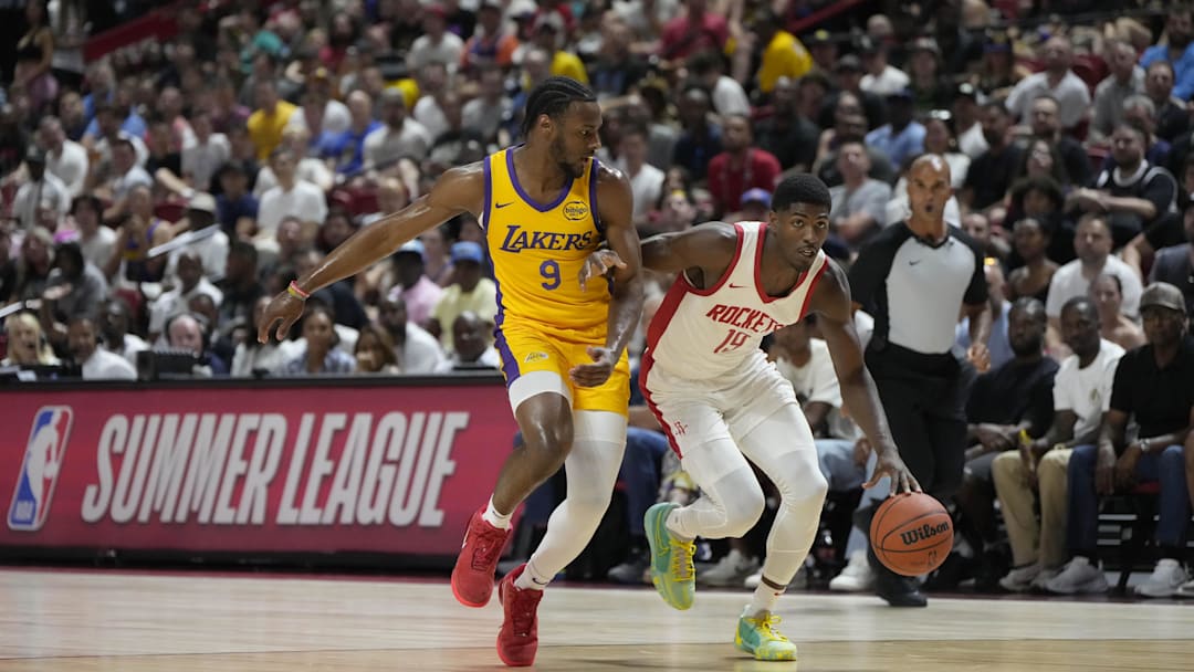 Jul 12, 2024; Las Vegas, NV, USA;  Houston Rockets guard Nate Williams (19) drives the ball against Los Angeles Lakers guard Bronny James (9) during the first half at the Thomas & Mack Center. Mandatory Credit: Lucas Peltier-Imagn Images