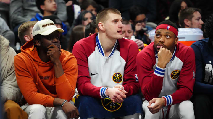 Feb 15, 2023; Denver, Colorado, USA; Denver Nuggets point guard Reggie Jackson (7) and center Nikola Jokic (center) and forward Bruce Brown (11) on the bench in the third quarter against the Dallas Mavericks at Ball Arena. Mandatory Credit: Ron Chenoy-USA TODAY Sports