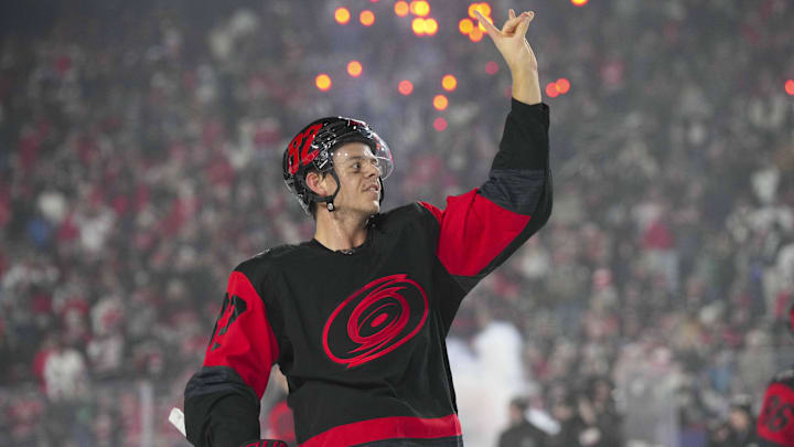 Feb 18, 2023; Raleigh, North Carolina, USA; Carolina Hurricanes center Jesperi Kotkaniemi (82) waves to the crowd after the game against the Washington Capitals during the 2023 Stadium Series ice hockey game at Carter-Finley Stadium. Mandatory Credit: James Guillory-Imagn Images