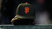 General view of a San Francisco Giants cap and glove during the ninth inning against the Colorado Rockies at Coors Field. 