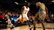 Cincinnati Bearcats guard Jizzle James (2) dribbles the ball as Alabama State Hornets guard TJ Madlock (20) covers him in the first half of the NCAA basketball game at Fifth Third Arena in Cincinnati on Wednesday, Nov. 27, 2024.
