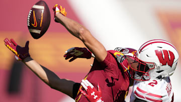 Sep 28, 2024; Los Angeles, California, USA; Southern California Trojans wide receiver Duce Robinson (2) attempts to catch the ball against Wisconsin Badgers cornerback Ricardo Hallman (2) in the second half at United Airlines Field at Los Angeles Memorial Coliseum. Mandatory Credit: Kirby Lee-Imagn Images