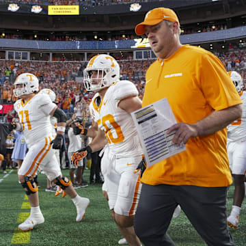 Sep 7, 2024; Charlotte, North Carolina, USA; Tennessee Volunteers head coach Josh Heupel heads onto the field during the first quarter against the North Carolina State Wolfpack at the Dukes Mayo Classic at Bank of America Stadium. Mandatory Credit: Jim Dedmon-Imagn Images