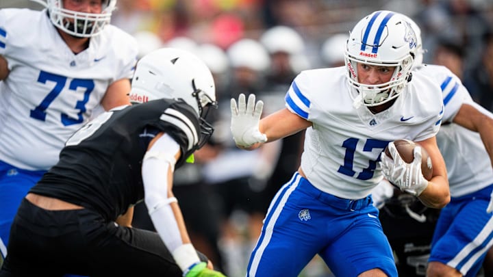 Waukee Northwest's Elliot Combe (17) dodges a Roosevelt defender on his way in for a touchdown on Thursday, Sept. 12, 2024, at Mediacom Stadium in Des Moines.