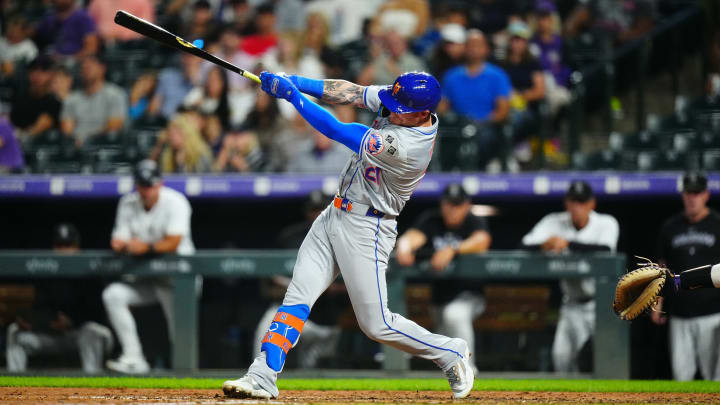 Aug 7, 2024; Denver, Colorado, USA; New York Mets outfielder Ben Gamel (21) singles in the seventh inning against the Colorado Rockies at Coors Field.