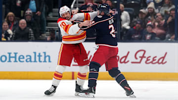 Blue Jackets winger Mathieu Olivier fights Flames forward Ryan Lomberg. 