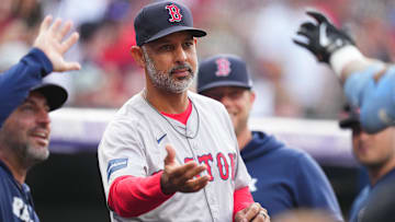 Boston Red Sox manager Alex Cora (13) celebrates a two-run home run scored at Coors Field.