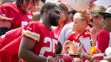 Jul 22, 2024; St. Joseph, MO, USA; Kansas City Chiefs running back Clyde Edwards-Helaire (25) signs autographs for fans after training camp at Missouri Western State University. 