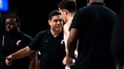 Cincinnati Bearcats guard Connor Hickman (8) listens to instructions from UC head coach Wes Miller in the Wednesday, Nov. 27 win over Alabama State.