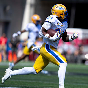 Pittsburgh Panthers running back Derrick Davis Jr. (34) runs downfield as Cincinnati Bearcats cornerback Logan Wilson (13) attempts to stop him in the third quarter of the College Football game at Nippert Stadium in Cincinnati on Saturday, Sept. 7, 2024.