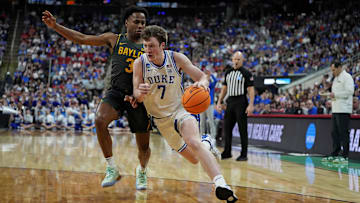 Duke Blue Devils guard Kon Knueppel drives to the basket as Baylor Bears guard Jeremy Roach defends during the first half in the second round of the NCAA Tournament at Lenovo Center. 