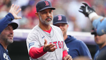 Boston Red Sox manager Alex Cora (13) celebrates a two-run home run scored by outfielder Tyler O'Neill (17) (not pictured) in the first inning against the Colorado Rockies at Coors Field.