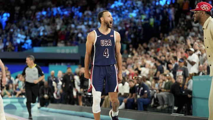 Aug 10, 2024; Paris, France; United States point guard Stephen Curry (4) celebrates with Carmelo Anthony in the second half against France in the men's basketball gold medal game during the Paris 2024 Olympic Summer Games at Accor Arena. Mandatory Credit: Kyle Terada-USA TODAY Sports