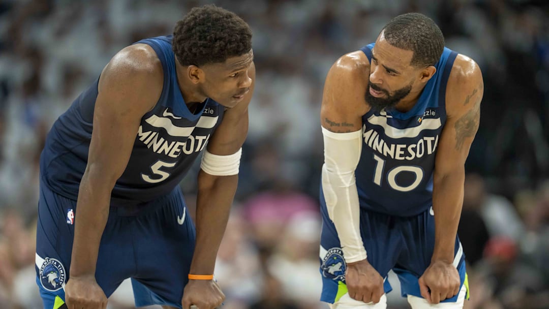 May 14, 2025; Minneapolis, Minnesota, USA; Minnesota Timberwolves guard Anthony Edwards (5) looks on with Minnesota Timberwolves guard Mike Conley (10) against the Golden State Warriors in the first half during game five of the second round for the 2025 NBA Playoffs at Target Center. Mandatory Credit: Jesse Johnson-Imagn Images