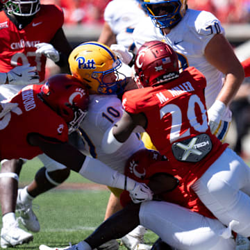 Cincinnati Bearcats linebacker Quinn Staten (41) Cincinnati Bearcats' Mehki Miller (20) and Cincinnati Bearcats defensive lineman Cam Roetherford (26) tackled Pittsburgh Panthers quarterback Eli Holstein (10) in the first quarter of the College Football game at Nippert Stadium in Cincinnati on Saturday, Sept. 7, 2024.