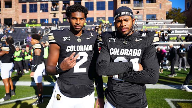 Nov 29, 2024; Boulder, Colorado, USA; Colorado Buffaloes quarterback Shedeur Sanders (2) and safety Shilo Sanders (21) pose f