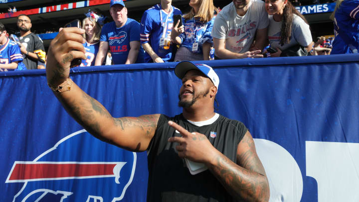 Oct 8, 2023; London United Kingdom, Buffalo Bills offensive tackle Dion Dawkins (73) poses with fans during an NFL International Series game against the Jacksonville Jaguars at Tottenham Hotspur Stadium. Mandatory Credit: Kirby Lee-USA TODAY Sports