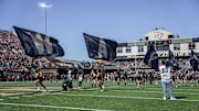 Oct 12, 2024; Winston-Salem, North Carolina, USA; Wake Forest Demon Deacons cheerleaders lead their team onto the field during the first half against the Clemson Tigers at Allegacy Federal Credit Union Stadium. Mandatory Credit: Jim Dedmon-Imagn Images