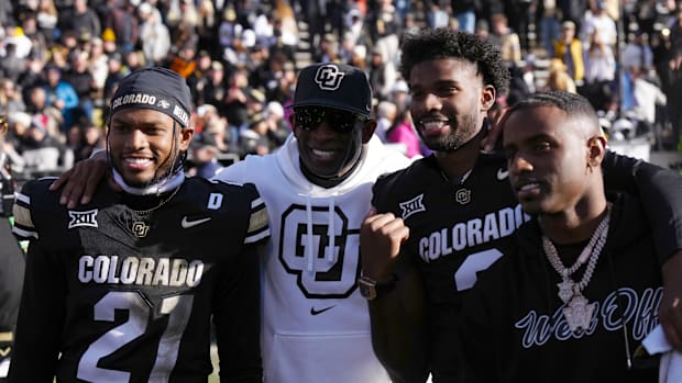 Nov 29, 2024; Boulder, Colorado, USA; Colorado Buffaloes safety Shilo Sanders (21) and head coach Deion Sanders and quarterba