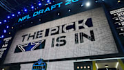 The Dallas Cowboys logo is projected on the video board during the NFL Draft at Lambeau Field