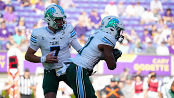 Nov 4, 2023; Greenville, North Carolina, USA; Tulane Green Wave quarterback Michael Pratt (7) hands the ball off to running back Makhi Hughes (21) against the East Carolina Pirates during the first half at Dowdy-Ficklen Stadium.