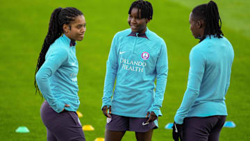 Nov 22, 2024; Kansas City, Missouri, USA; Orlando Pride midfielder Grace Chanda (23) talks with midfielder Evelina Duljan (17) and forward Barbra Banda (22) during a training session ahead of the 2024 NWSL Championship against the Washington Spirit at CPKC Stadium. Mandatory Credit: Jay Biggerstaff-Imagn Images