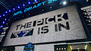 The Dallas Cowboys logo is projected on the video board during the NFL Draft at Lambeau Field. 