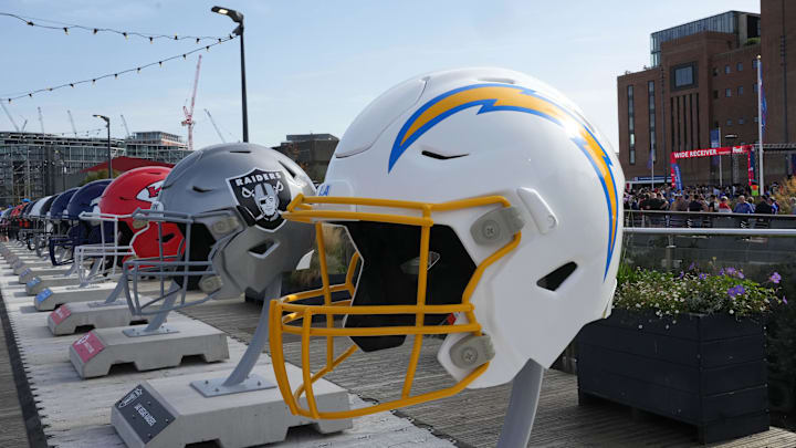 Oct 7, 2023; London, United Kingdom; Large oversized helmets of the Los Angeles Chargers, Las Vegas Raiders and Kansas City Chiefs at the NFL Experience London at the Battersea Power Station. Mandatory Credit: Kirby Lee-Imagn Images