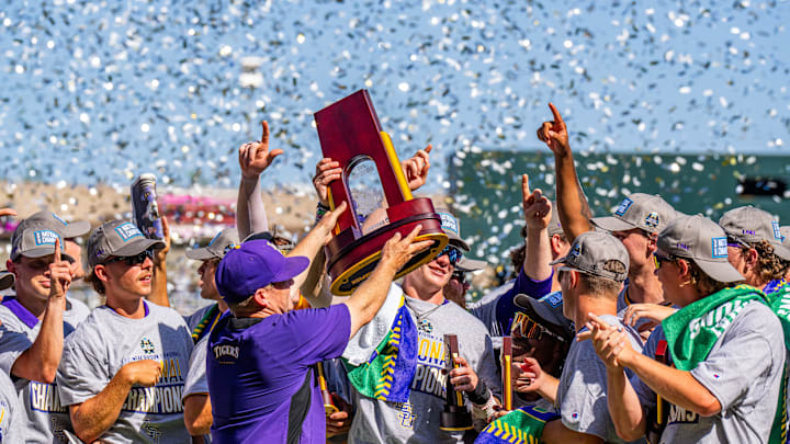 Jun 22, 2025; Omaha, Neb, USA; LSU Tigers head coach Jay Johnson hoists the trophy after winning the College World Series at Charles Schwab Field. Mandatory Credit: Dylan Widger-Imagn Images