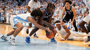 Mar 8, 2025; Chapel Hill, North Carolina, USA;  Duke Blue Devils guard Sion James (14) with the ball as North Carolina Tar Heels guard Elliot Cadeau (3) defends in the first half at Dean E. Smith Center. Mandatory Credit: Bob Donnan-Imagn Images