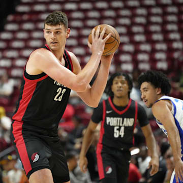 Jul 15, 2024; Las Vegas, NV, USA; Portland Trail Blazers center Donovan Clingan (23) controls the ball against the Philadelphia 76ers  during the first half at Thomas & Mack Center. Mandatory Credit: Lucas Peltier-Imagn Images