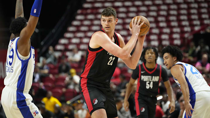 Jul 15, 2024; Las Vegas, NV, USA; Portland Trail Blazers center Donovan Clingan (23) controls the ball against the Philadelphia 76ers  during the first half at Thomas & Mack Center. Mandatory Credit: Lucas Peltier-Imagn Images