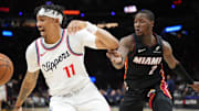 Mar 12, 2025; Miami, Florida, USA;  LA Clippers guard Jordan Miller (11) saves the ball from going out of bounds in front of Miami Heat guard Terry Rozier (2) during the second half at Kaseya Center. Mandatory Credit: Jim Rassol-Imagn Images