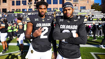 Shedeur Sanders (2) and safety Shilo Sanders (21) pose for a photo before the game against the Oklahoma State Cowboys at Folsom Field.